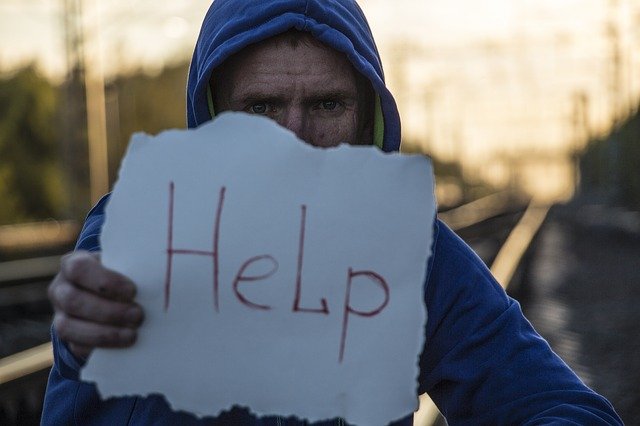 man with help sign