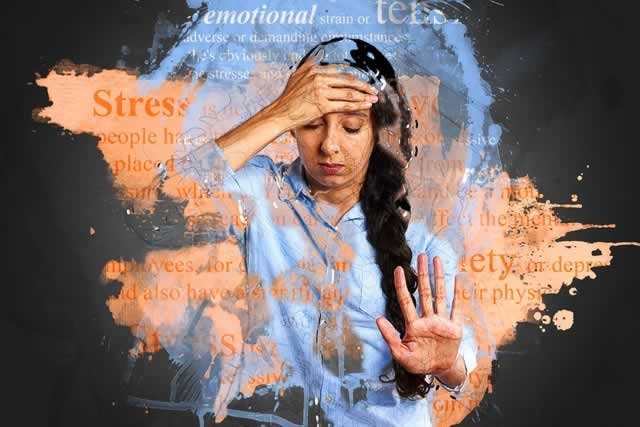 woman with hand on forehead surrounded by words stress anxiety etc