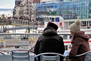 two people on a pier talking